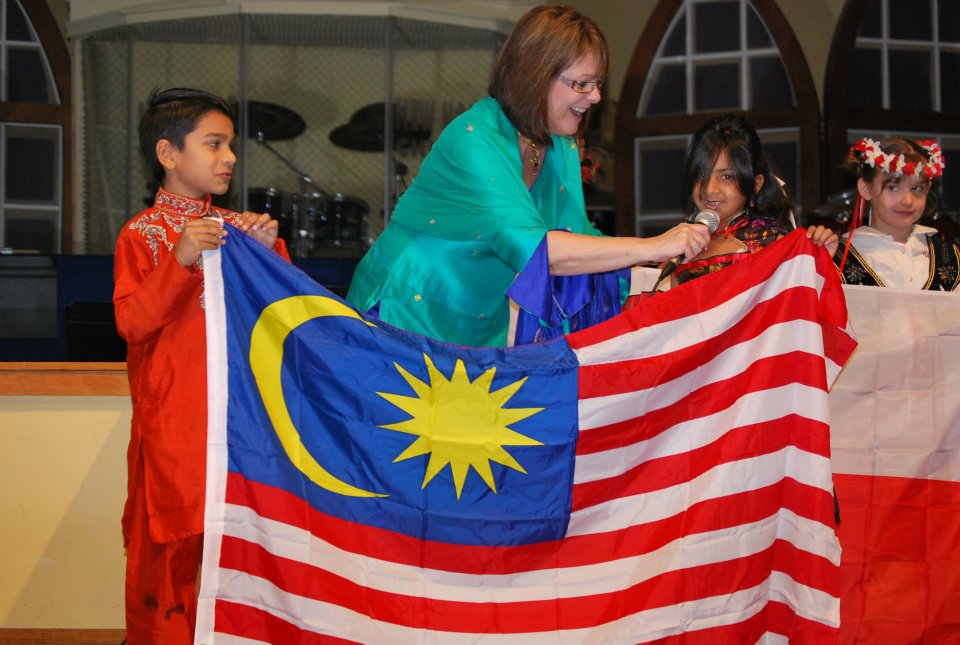 Students holding a world flag at a cultural celebration