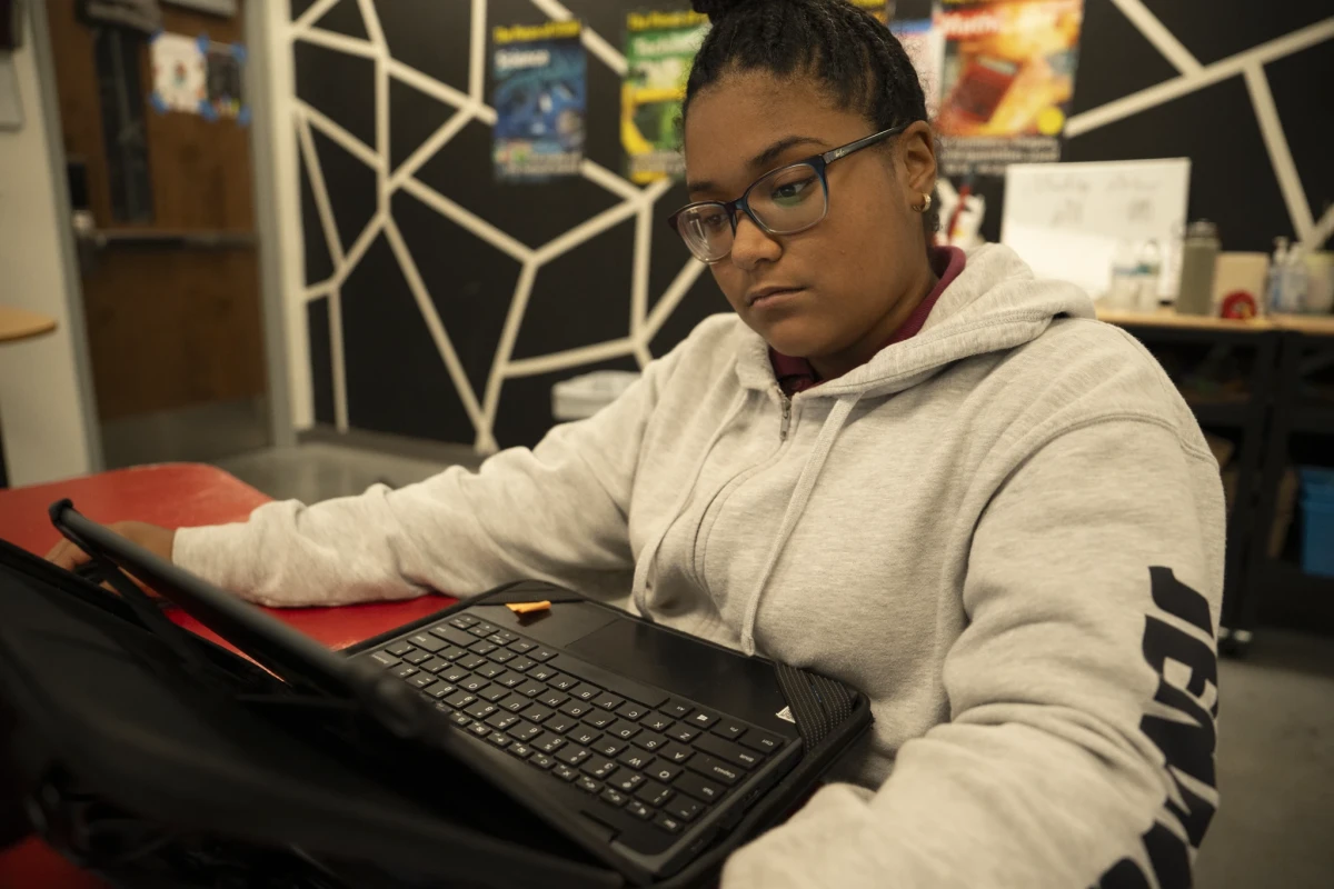 A Central Florida Prep high school student works at a laptop in a classroom