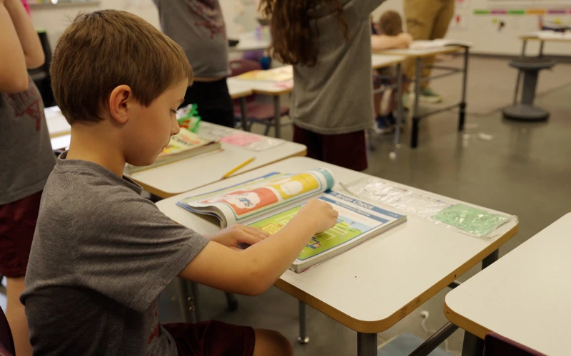 A young Central Florida Prep student reading in class