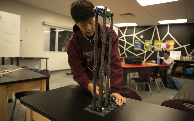 A Central Florida Prep student building a robot in the STEM lab