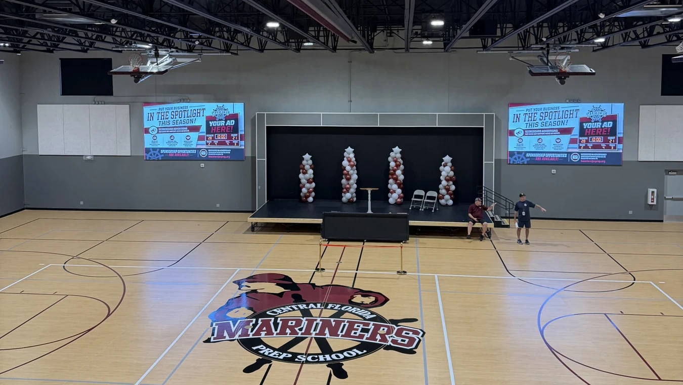 The competition gymnasium inside the Robert A. Flanders Athletic & Performing Arts Center at Central Florida Prep, with the Mariners logo at center court