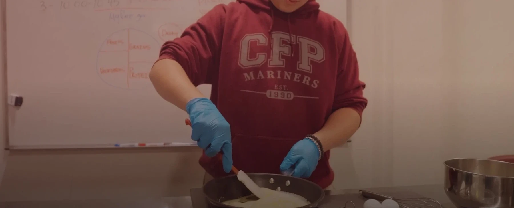A student at work in the culinary arts teaching kitchen
